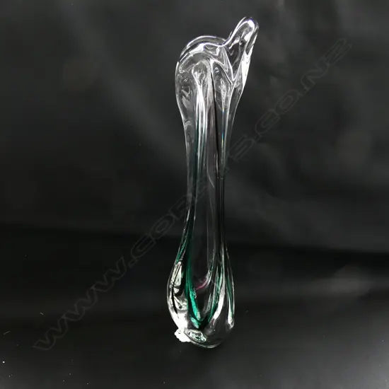 A tall slender glass vase